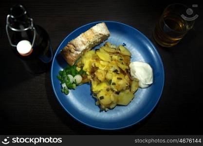 Fried potato sliced slices on a plate on a neutral background. Fried potato sliced slices on a plate