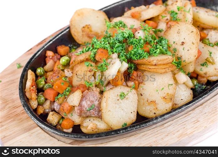 Fried potato with meat and vegetables on a white