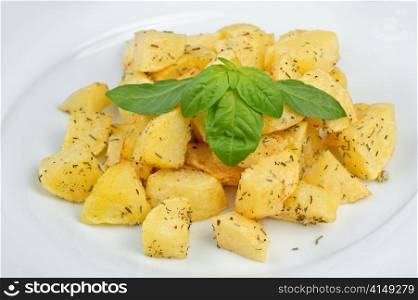 fried potato with spices and fresh basilic. fried potato with spices