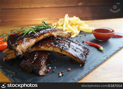 fried potatoes and pork ribs on aplate