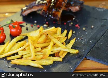 fried potatoes and pork ribs plate