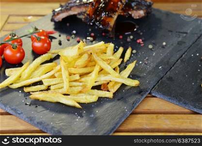 fried potatoes and pork ribs plate