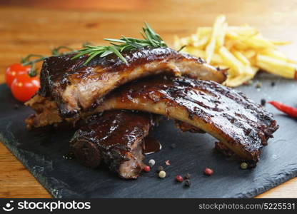 fried potatoes and pork ribs plate. potatoes and pork ribs