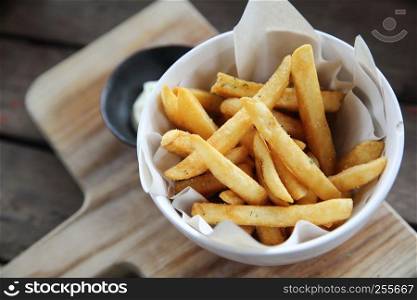 Fried potatoes french fries on wooden background