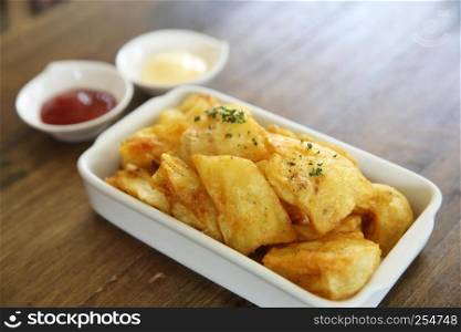 fried potatoes on wood background