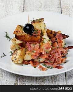 Fried Potatoes With Bacon In A White Plate