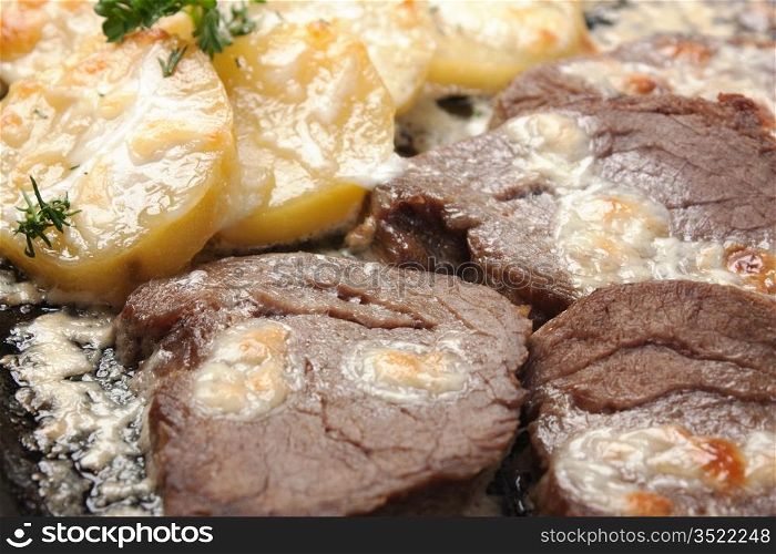 fried potatoes with meat and sour cream