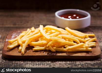 fried potatoes with sauce on wooden table