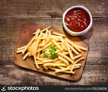 fried potatoes with sauce on wooden table