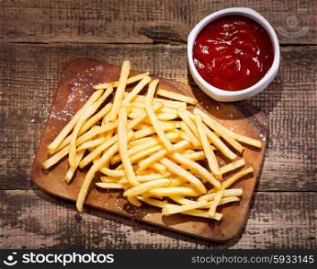 fried potatoes with sauce on wooden table
