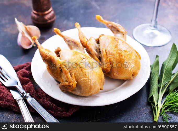 fried quail with spice on plate and on a table