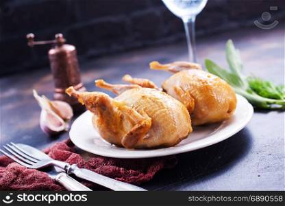 fried quail with spice on plate and on a table