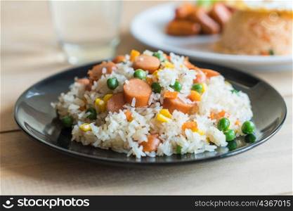 fried rice with sausage on the table