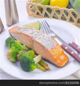 Fried salmon fillet on a white plate with lemon or lime slices, sauce and herbs. Delicious, appetizing restaurant diet dish. AI generated.. Grilled salmon fillet on a white plate with lemon or lime wedges, sauce and herbs. AI generated.