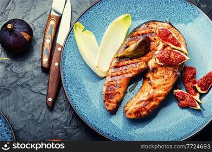 Fried salmon steak with figs.Baked trout with garnish. Roasted salmon with figs