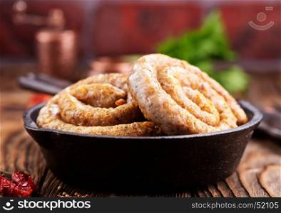 fried sausages in the pan and on a table