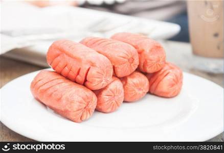 Fried sausages on white plate, stock photo