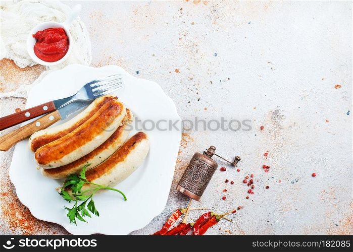 fried sausages with sauce on a table