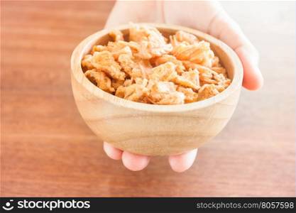Fried shrimp chins snack in wooden bowl, stock photo