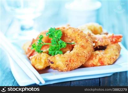 fried shrimps on plate and on a table