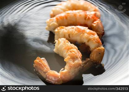 Fried shrimps on the black background