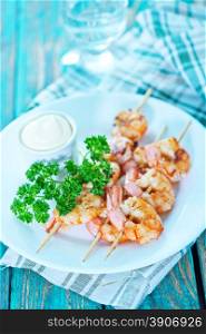 fried shrimps on white plate and on a table
