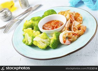 fried shrimps with boiled broccoli and sauce