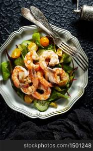 fried shrimps with fresh salad on plate