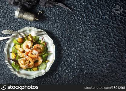 fried shrimps with fresh salad on plate