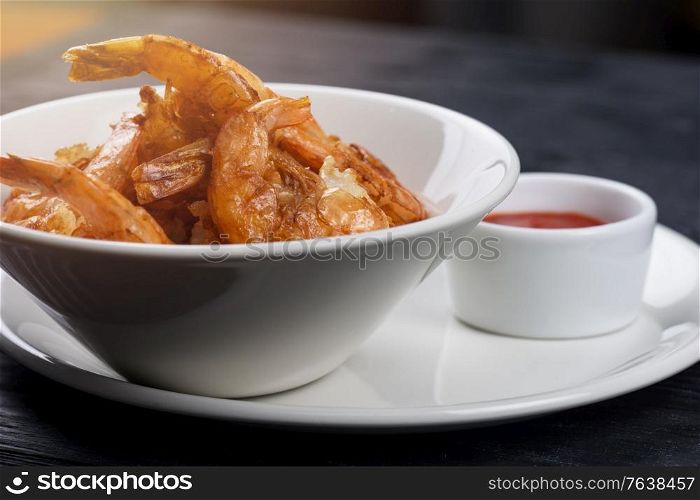 Fried shrimps with tomato sauce on plate. Fried tasty shrimps