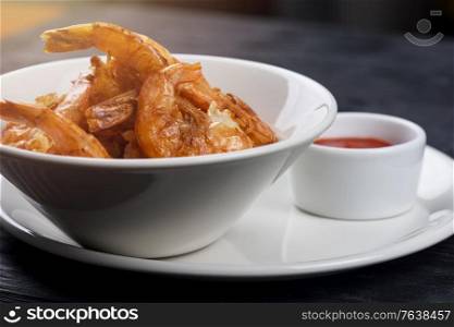 Fried shrimps with tomato sauce on plate. Fried tasty shrimps