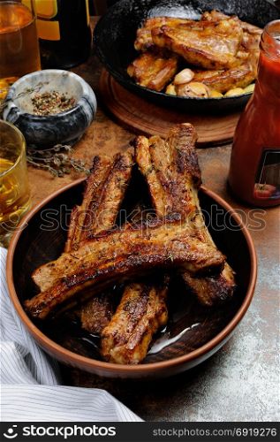 Fried spicy, sharp pork ribs with beer and ketchup. Vertical shot.