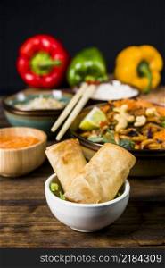 fried spring rolls white bowl with thai food wooden desk