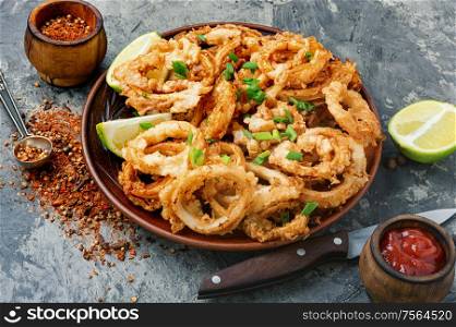 Fried squid or calamari rings with sauce. Crispy fried squid rings