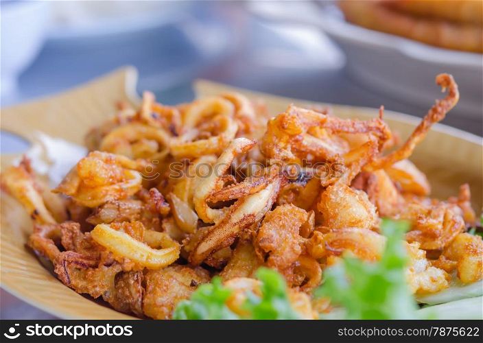 fried squids . fried squids and garlic served with vegetable on dish