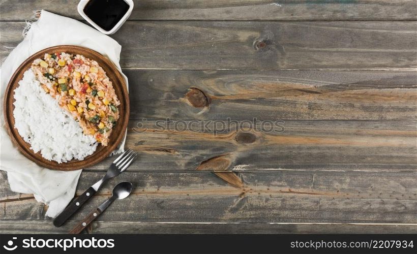 fried steamed rice wooden plate with fork spoon table
