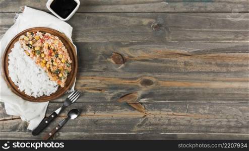 fried steamed rice wooden plate with fork spoon table