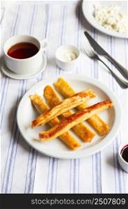 Fried Stuffed Pancakes Blintzes. Russian thin pancakes with cottage cheese, sour cream and jam. Healthy traditional breakfast.Tasty stuffed pancakes crepes with fillings. Children&rsquo;s menu.