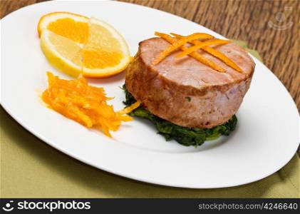 fried tuna fillet with fresh orange ,orange sauce and spinach