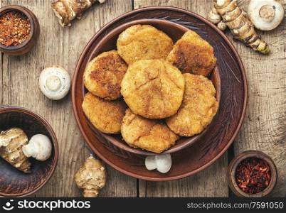 Fried vegetable cutlets with Jerusalem artichoke and mushrooms.Rissole on wooden table.Healthy food. Healthy vegetable cutlets