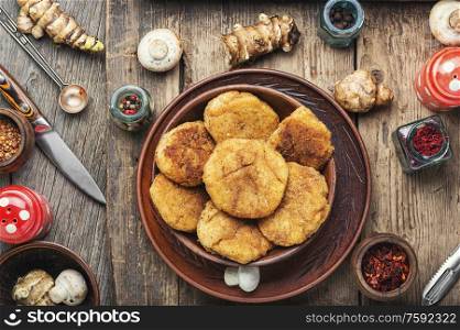Fried vegetable cutlets with Jerusalem artichoke and mushrooms.Rissole on wooden table.Healthy food. Cutlets from Jerusalem artichoke and mushrooms
