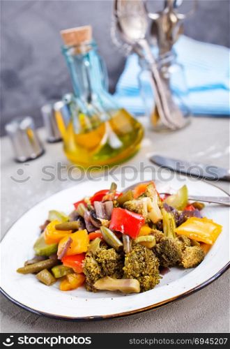 fried vegetables on plate and on a table