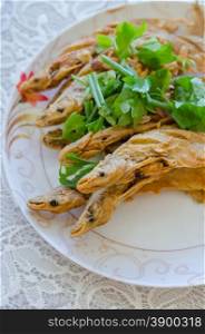 Fried Whisker Sheatfish . Fried river fish with garlic and pepper
