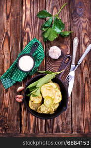 fried zucchini in metal pan and on a table