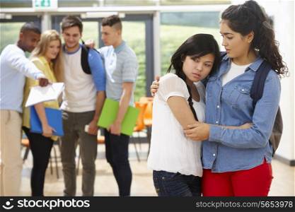 Friend Comforting Victim Of Bullying At School