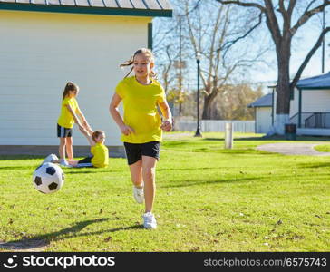 Friend girls teens playing football soccer in a park turf grass