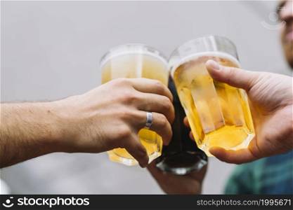 friend s hand toasting glass beer