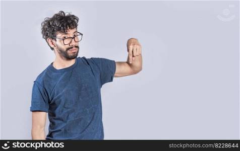 Friendly bearded man pointing down on isolated background, friendly guy pointing down and recommending