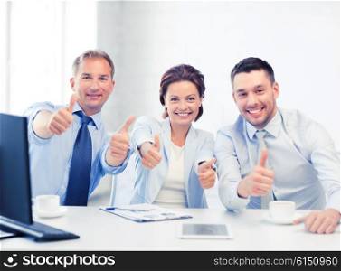 friendly business team showing thumbs up in office. business team showing thumbs up in office