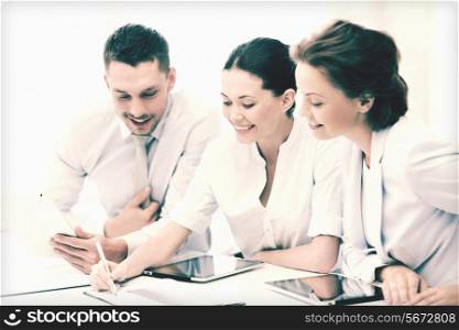friendly business team with tablet pcs having discussion in office